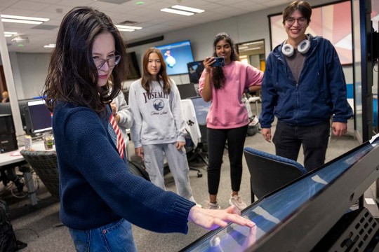 Faculty Hye-Jin Nae uses a large touchscreen, for a student project.