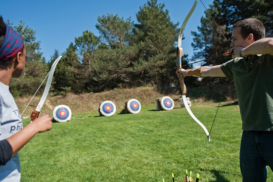 Two students shooting at targets on the archery range.
