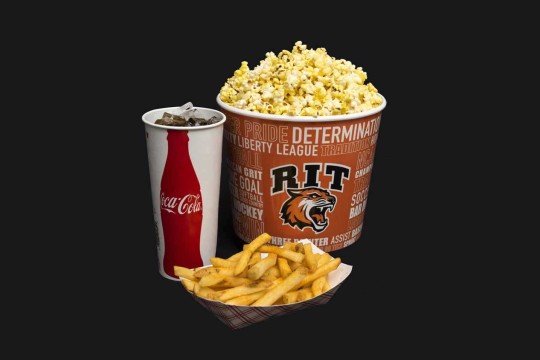 Fries, popcorn, and a fountain drink on a black background