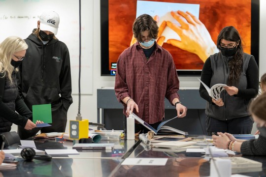 students looking through photo books.