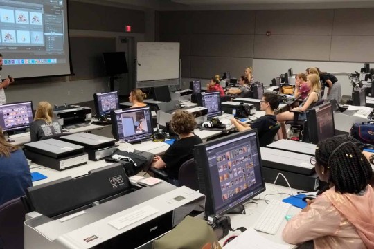 Large lecture hall with computers and printers at each station