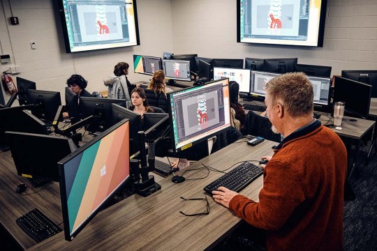 A group of medical illustration students work in a lab.