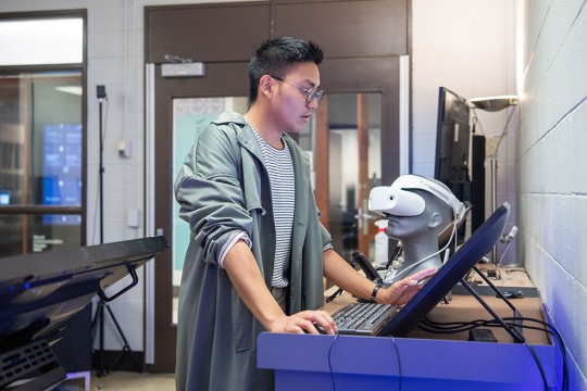 Student Gabe Cagera works on screen in the New Media Workshop.