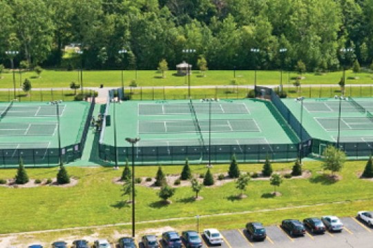 Aerial view of 9 tennis courts.