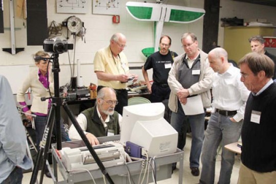 People surrounding Person using computer