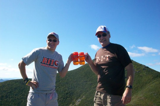 People posing at the top of mountain