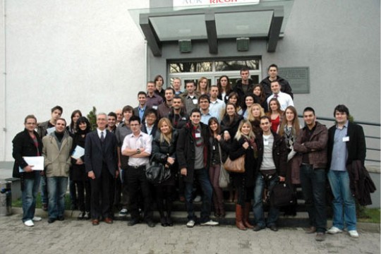 People gathered in front of building for picture