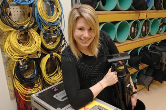 Student posing with photography equipment
