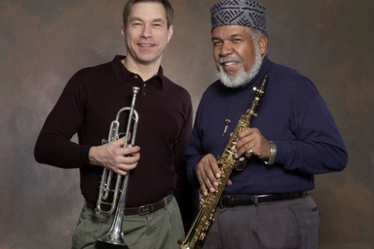 Two musicians posing for camera