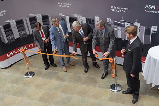 People cutting the ribbon at ceremony 