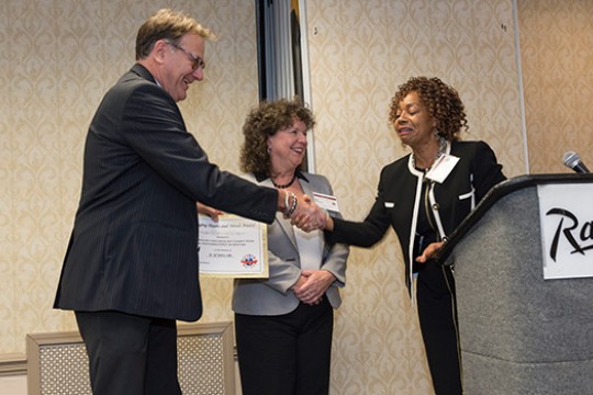 People shaking hands at event