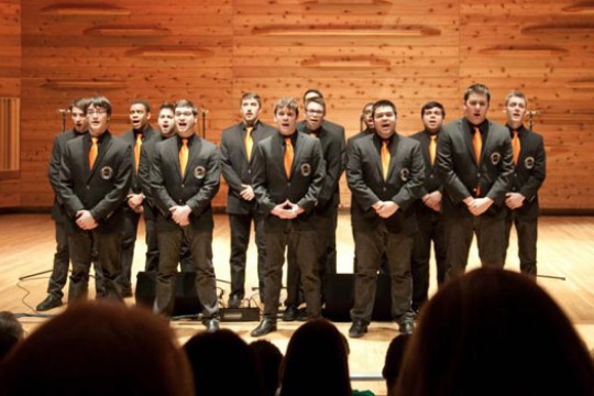 People singing on wooden stage