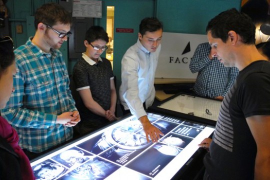 People looking at lit up diagrams