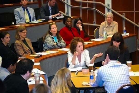 People sitting around table in theater