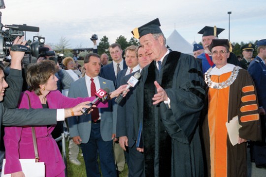 People shaking hands with former US president