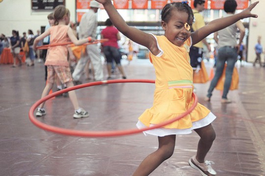 young girl hula hooping.
