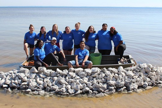group of people in and around a small boat.
