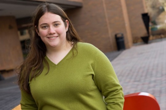 A portrait of Ashley Aberg standing outside the College of Liberal Arts building.