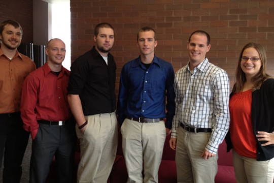 Six people posing for camera