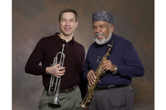 Two musicians posing for camera