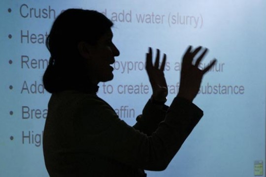 Professor teaching in front of a slideshow 
