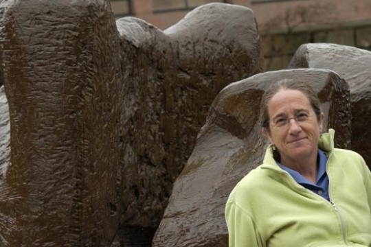 Professor standing in front of sculpture