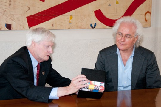 RIT president talking with person at table