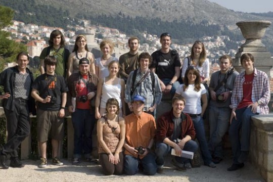 Students taking group phot in front of city view