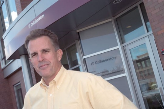 Professor Standing in front of building