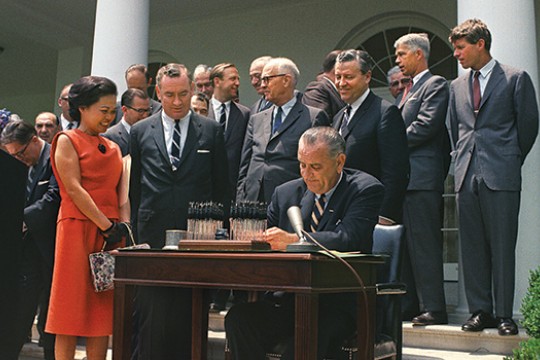 United States of America President signing paperwork outside