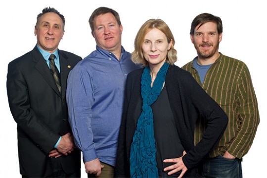 Four RIT faculty members pose for photo in front of white screen.