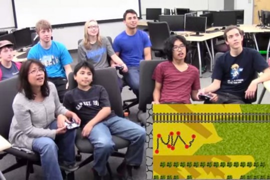 People in classroom playing game