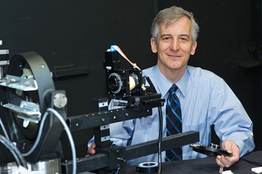 Person posing next to machine