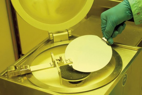 Hand putting disk into a machine