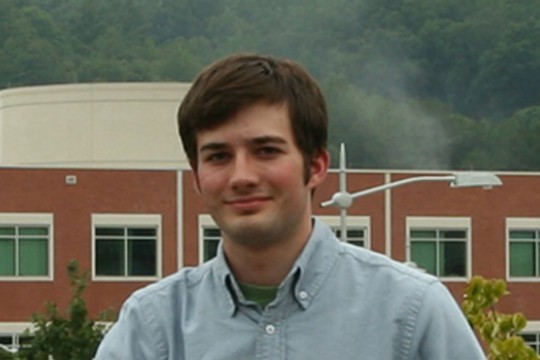 Student posing in front of building