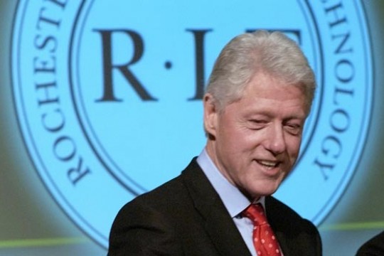 Person standing in front of RIT logo