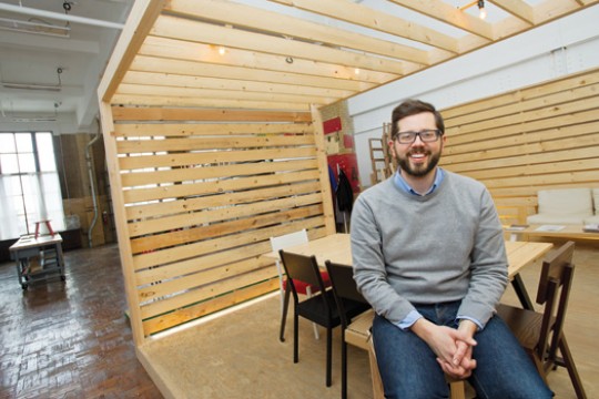 Person posing next to custom desk