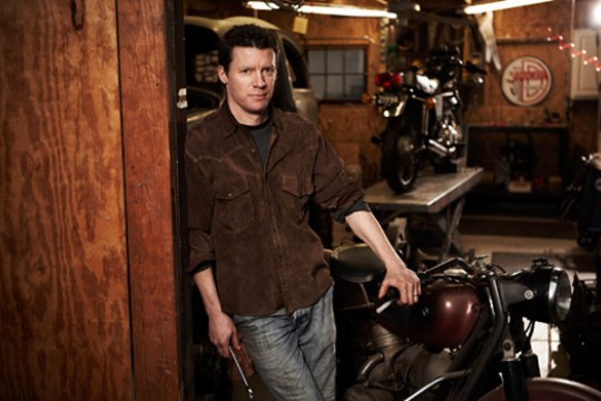 Person posing next to motorcycle