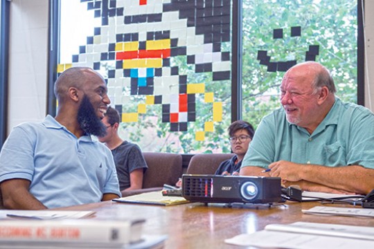 People talking at table in classroom