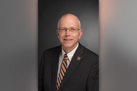 Headshot of President Munson in a suit.