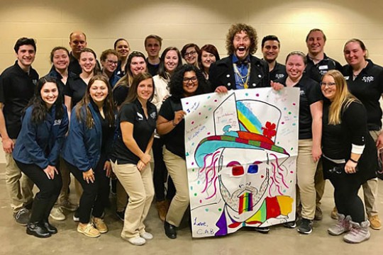 Members of the College Activities Board pose for a photo with T.J. Miller.