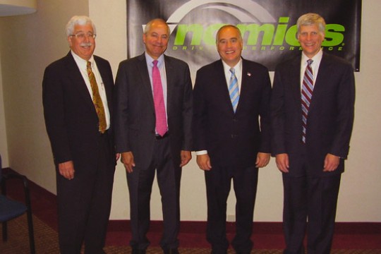 Four people posing for picture at event