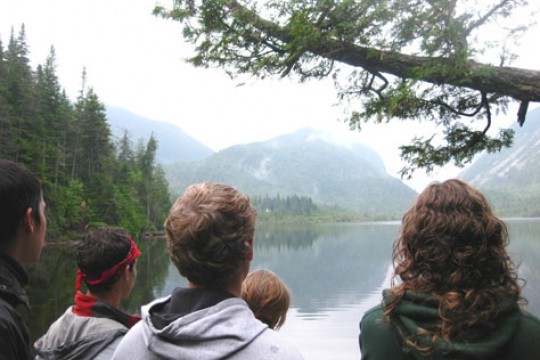People looking at lake and mountains