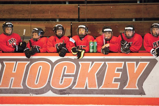 Kids posing in hockey gear