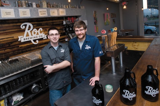 People posing behind counter