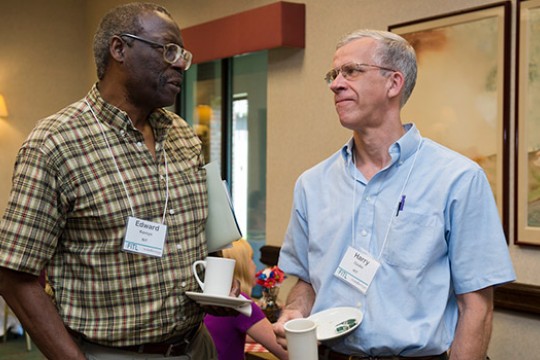 Two people talking at event.