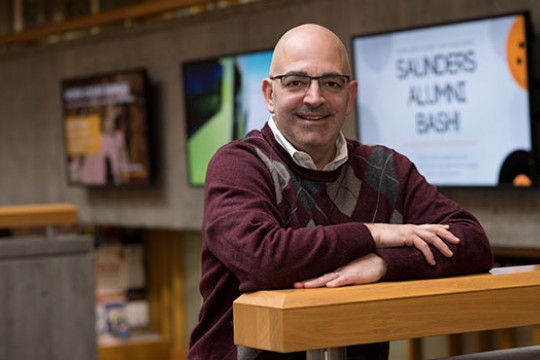 Philip Gelsomino in a maroon sweater poses for photo.