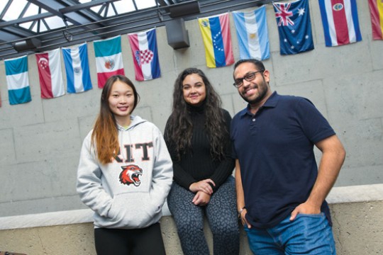 People posing in front of flags 
