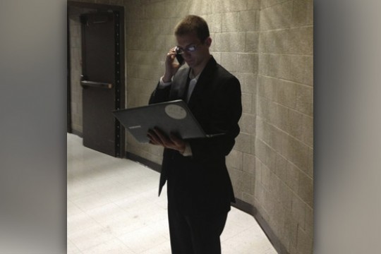 Person posing for camera with computer