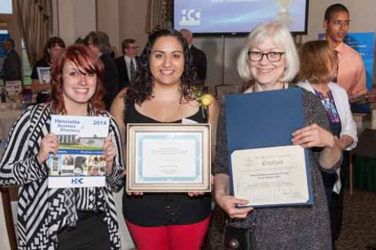 People posing with awards at event